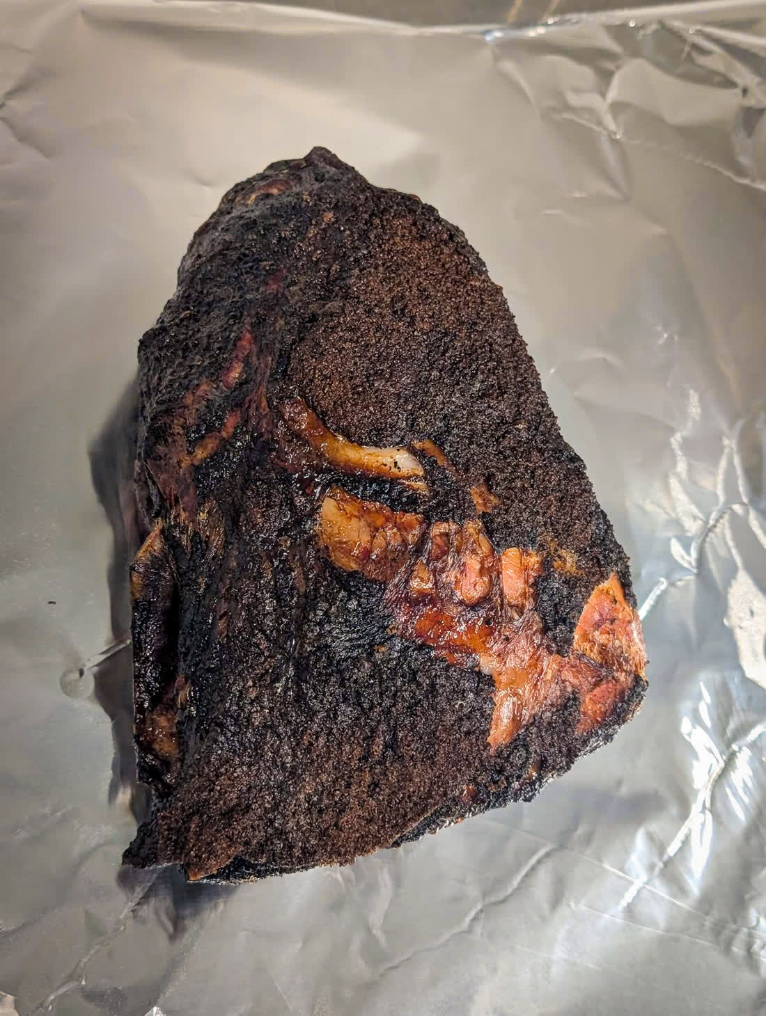 Smoked brisket fresh off the smoker with a deep, glossy bark
